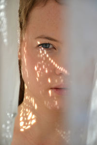 Close-up of portrait of woman with shadow