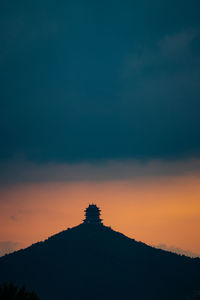 Silhouette mountain against sky at sunset