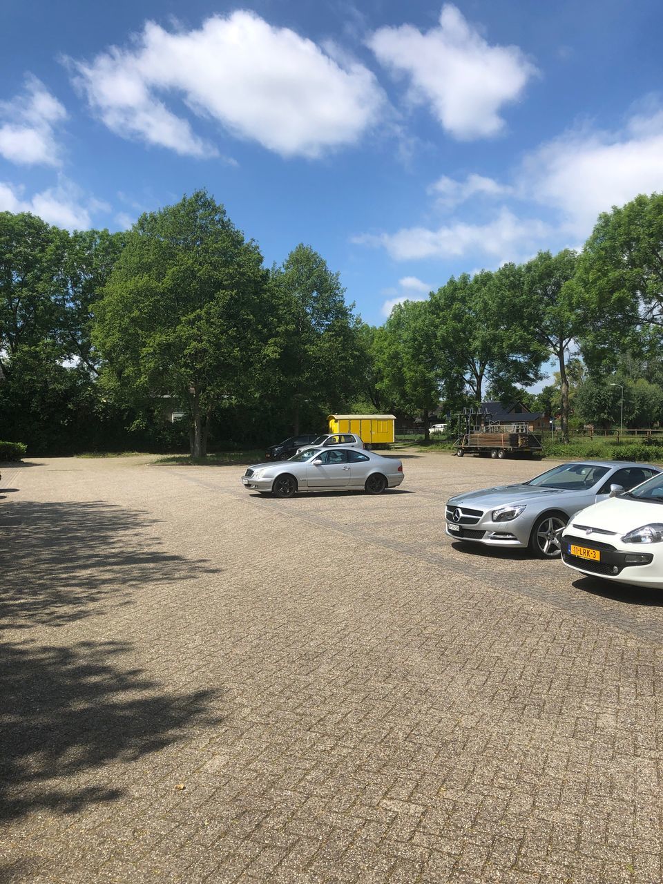 VEHICLES ON ROAD AGAINST SKY IN CITY