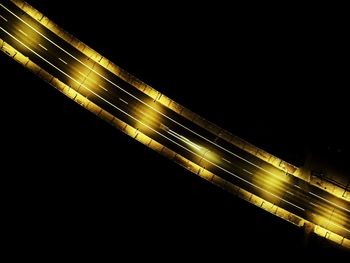 Illuminated light trails against clear sky at night