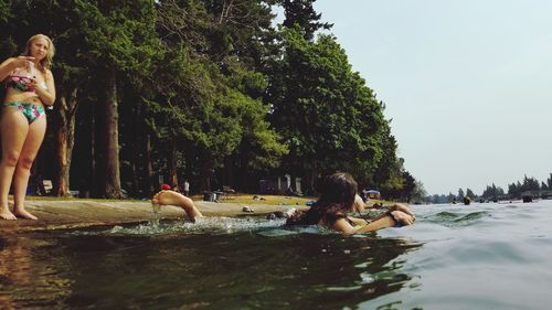 People enjoying in swimming pool against sky