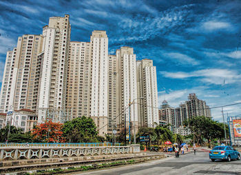 Buildings against cloudy sky