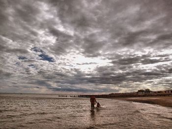 Man on beach against sky