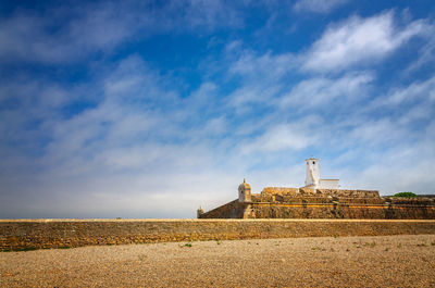 View of temple against cloudy sky