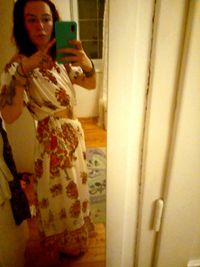 Reflection of woman on mirror at home