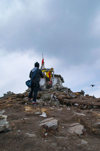 Men standing on mountain against sky