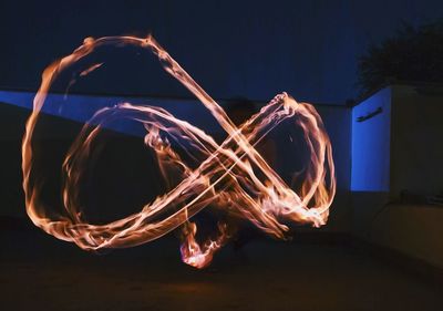 Light painting against fire at night