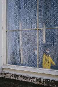 Man seen through glass window