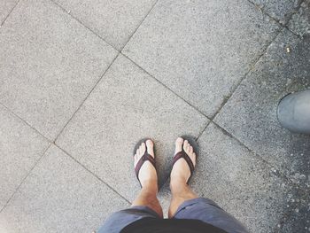 Low section of woman standing on tiled floor