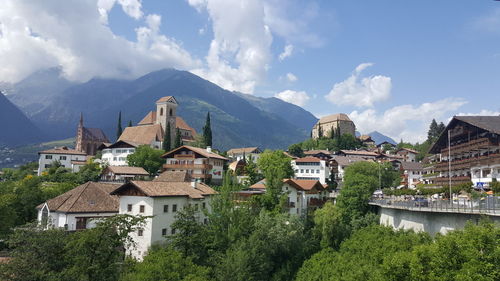 Panoramic view of buildings and mountains against sky