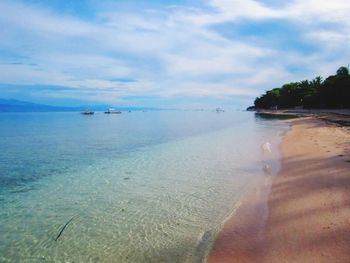 Scenic view of calm sea against cloudy sky