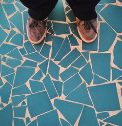 Low section of woman standing on tiled floor