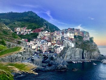 High angle view of townscape by sea against sky