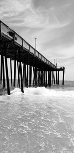 Surf crashing on wooden pier