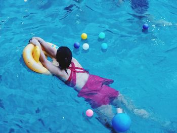 High angle view of boy swimming in pool