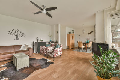 Rear view of woman sitting on hardwood floor at home