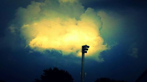 Low angle view of street light against cloudy sky