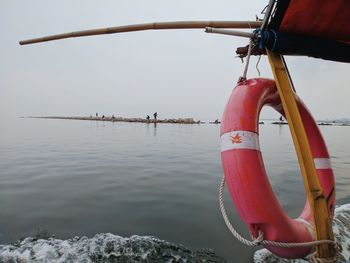 Sailboat in lake against sky