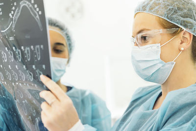 Female dentists examining x-ray at clinic