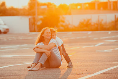 Portrait of smiling young woman sitting outdoors