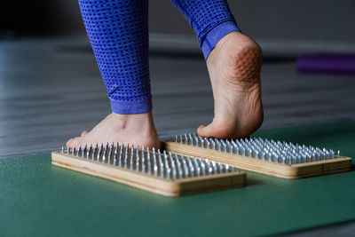Low section of woman standing on table