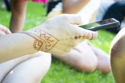 Close-up of hands holding grass