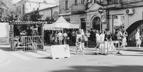 People on street against buildings in city