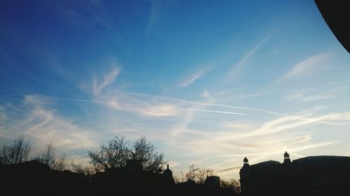 Low angle view of silhouette trees against sky at sunset