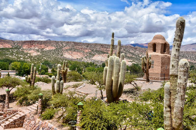 Panoramic view of buildings on landscape against cloudy sky