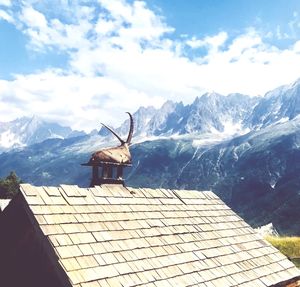 House on mountain against sky