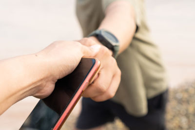 Midsection of man using mobile phone