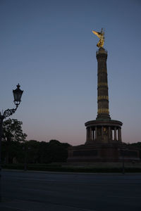 Statue in city at dusk