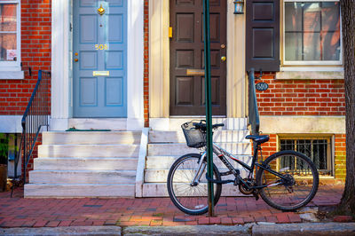 Bicycle on sidewalk against building