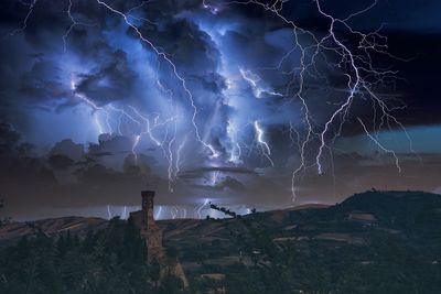 Low angle view of lightning against sky at night