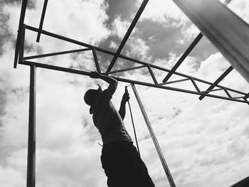 Low angle view of hand against sky