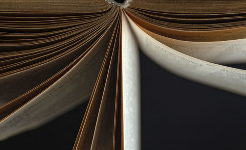 Open book, hardcover books on a dark background.