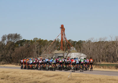 Rear view of cyclists riding bicycle on road sports race