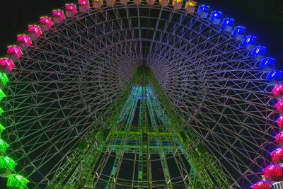 Low angle view of illuminated christmas lights against sky at night