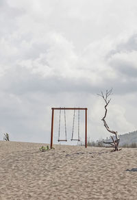 Lifeguard hut on beach against sky