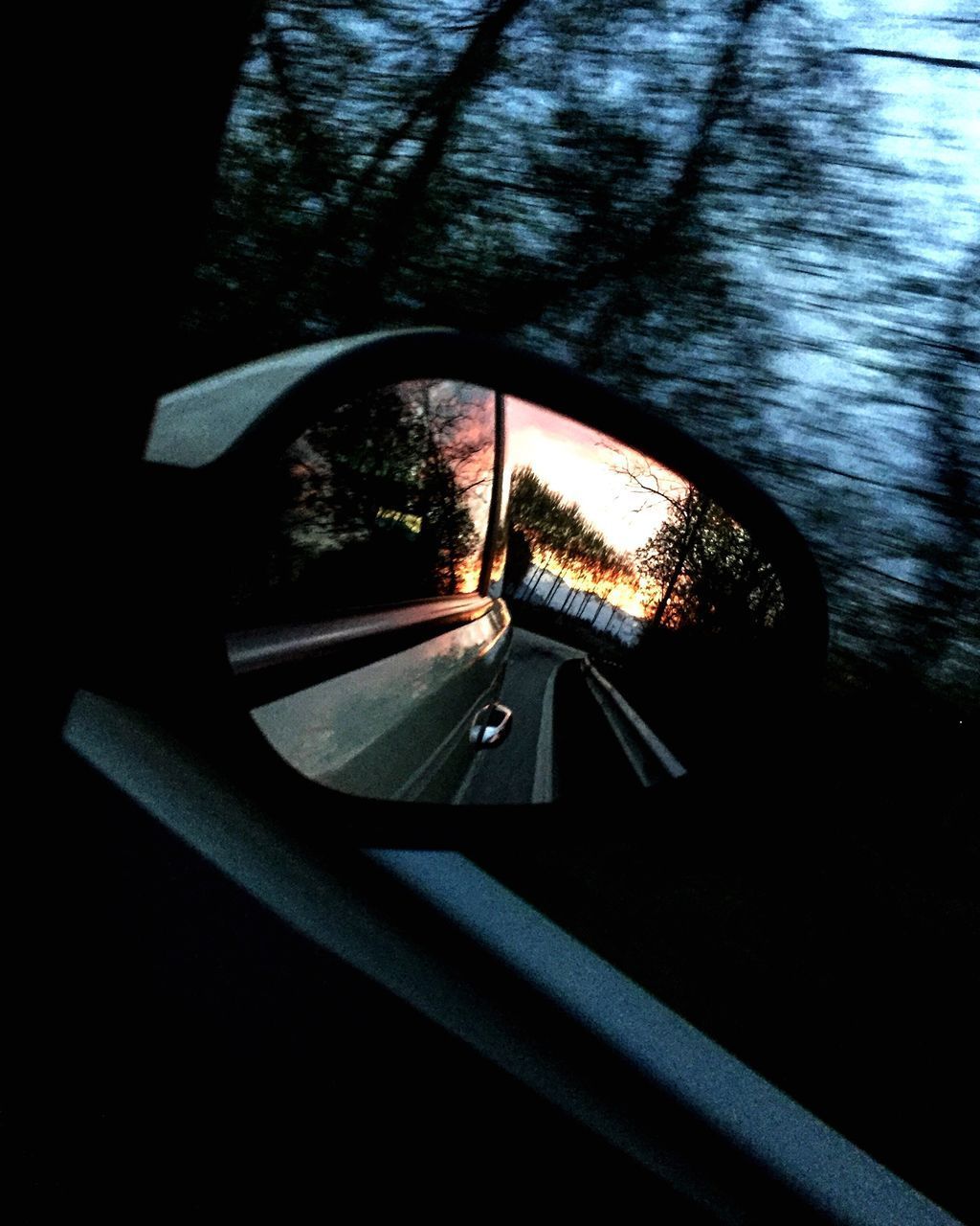 CLOSE-UP OF CAR ON ROAD SEEN THROUGH WINDOW