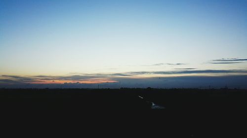 Scenic view of landscape against sky at sunset