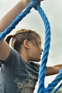 Portrait of cute girl standing on rope in playground