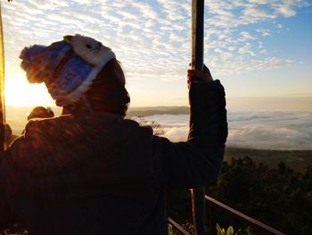 Rear view of woman looking at sunset