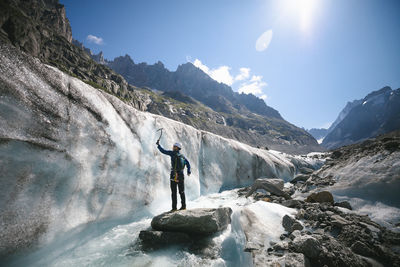 Man with pickax exploring mountains in winter