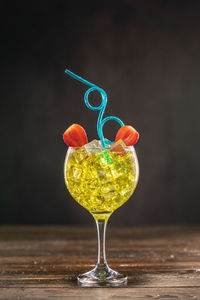 Close-up of wineglass on table against black background
