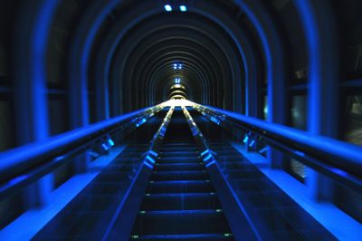 Low angle view of illuminated street lights at night