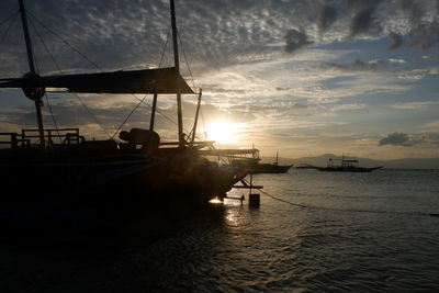 Sailboat sailing on sea against sky during sunset