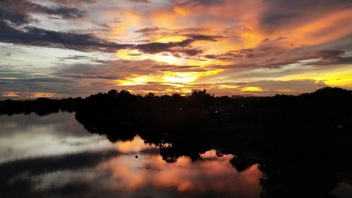 Scenic view of lake against orange sky