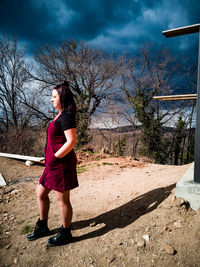 Full length of woman standing by tree against sky