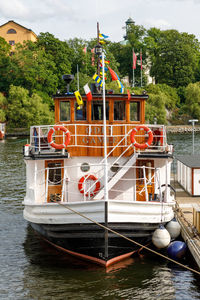 Boat moored on river against sky